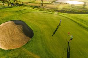 a golfer is standing on a green golf course at Murray Hill Bungalow in Jacksonville