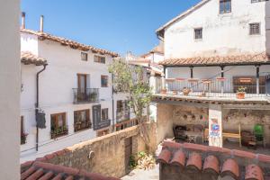 a group of white buildings with tables and chairs at Apartamento Casa El Cojo 2a in Alcalá de la Selva