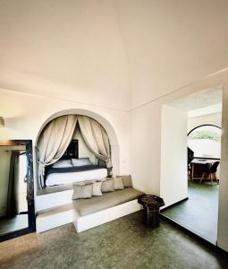 a bedroom with a bed with a canopy at Etherea - I Dammusini di Pantelleria in Pantelleria