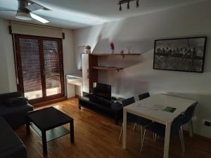 a living room with a table and chairs and a couch at Teruel 380 in Teruel