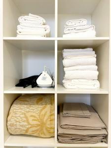 a walk in closet with towels and a phone at "Suite Sesto" Metro M1 to Milano, Rho Fiera, Monza in Sesto San Giovanni +14 photos