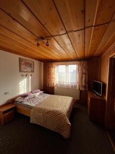 a bedroom with a bed in a wooden room at ,, U Nikoli" in Bukowina Tatrzańska