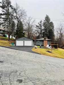 a house with a garage and a driveway at Vernon Cozy 2BD Pet-Friendly Mountain Creek in Vernon