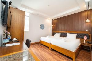Postel nebo postele na pokoji v ubytování Gigame Signature Hotel