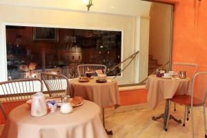 a restaurant with two tables and chairs and a window at Hotel Kent in Rome