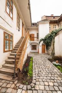 a stairway leading up to a white building with stairs at Altius Studio 2 in Braşov