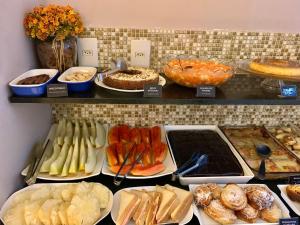 a display case with many different types of food at Riviera Hotel by Bsb Inn in Brasília