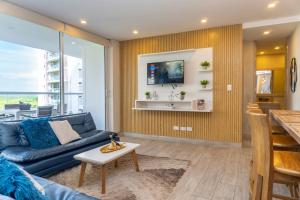 a living room with a blue couch and a table at Dominique Cartagena, Beautiful 2 Bedroom Apartment in Cartagena de Indias