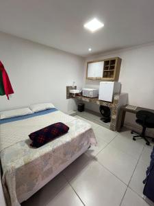 Ένα ή περισσότερα κρεβάτια σε δωμάτιο στο Pousada Anneliz