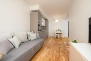 a living room with a couch and a table at 2 bedroom Family Apartment near Spa Tervise Paradiis in Pärnu