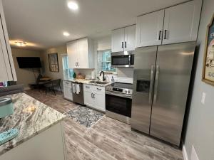 a kitchen with white cabinets and stainless steel appliances at Sunset Heaven in Navarre