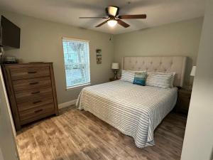 a bedroom with a bed and a ceiling fan at Sunset Heaven in Navarre +26 photos