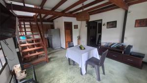 a room with a table and chairs and a bed at Iraka Campestre Quindio in El Edén