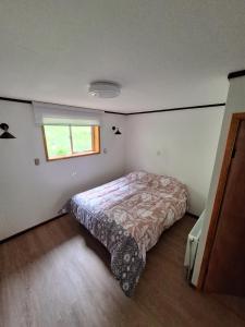 Ένα ή περισσότερα κρεβάτια σε δωμάτιο στο Cabañas y Hostel Praga +1 φωτογραφίες