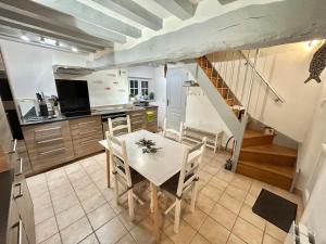 a kitchen and dining room with a table and chairs at Longère Normande in Sainte-Marguerite +30 photos