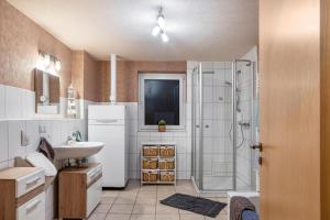 a bathroom with a sink and a shower at Ferienhaus Hof Schäfer in Waldeck +30 photos