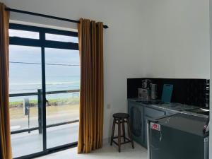 a kitchen with a window with a view of the beach at AYA Sea View Hotel in Ahangama
