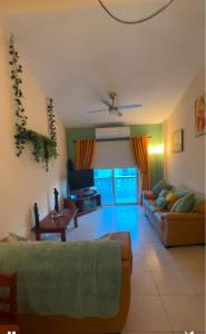 a living room with a couch and a table at Bar street apartment in Ayia Napa