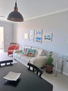 a living room with a couch and a table at Apartamento novo entre a praia dos Ingleses e Santinho in Florianópolis