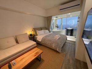 Postel nebo postele na pokoji v ubytování 所在行旅2館-渡咕所在 UrbanAbode2-DUGU