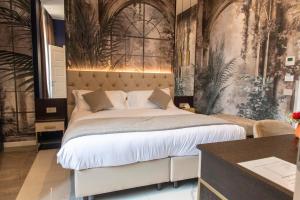 a bedroom with a large bed with a wall mural at Adelaide Suite Dreams in Rome