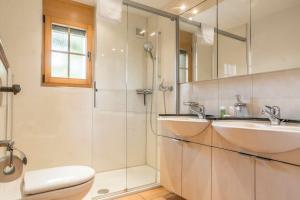 a bathroom with a sink and a shower at Chalet Heimat in Grindelwald +27 photos