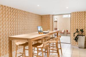 a dining room with a table and stools at Hôtel Terminus in Grenoble
