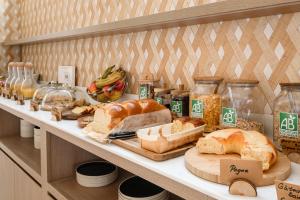 a shelf with bread and other food items on it at Hôtel Terminus in Grenoble