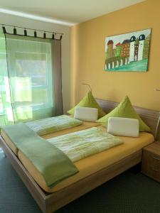 two beds in a bedroom with two laptops on them at Park-Hotel Leimen in Leimen