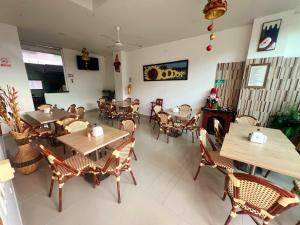 a restaurant with wooden tables and chairs and a fireplace at Hotel Suite Royal in Melgar