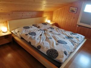 una camera da letto con un letto in una stanza di legno di Ferienhaus Rheintalblick a Oberegg
