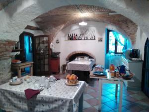 a living room with two tables and a fireplace at B&B Renzano bedrooms in Salò