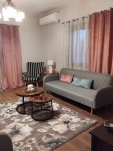 a living room with a couch and a chair at Vagia in Tríkala