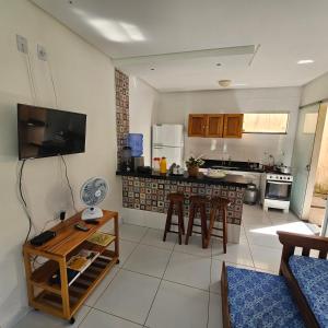 a kitchen with a table and chairs in a room at Vila Axé Flat 05 Riviera in Prado