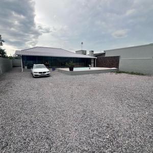 une voiture blanche garée devant un immeuble dans l'établissement Casa de praia na praia do sonho, à Ilha dos Cardos