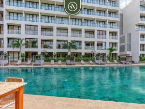 a swimming pool in front of a building at Luxury Condo with Canal View - Near Beach in Nuevo Vallarta  +23 photos
