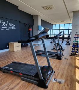 a gym with three treadmills in a room at Max Derby - Studios no Centro do Recife por Yolo in Recife