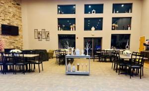 a dining room with tables and chairs and windows at Qube Hotel - Polk City in Polk City