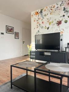 a living room with a flat screen tv on a wall at Apartament Andrea in Oleśnica