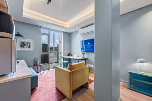 a kitchen and living room with blue walls at Quarters 405 in Cape Town
