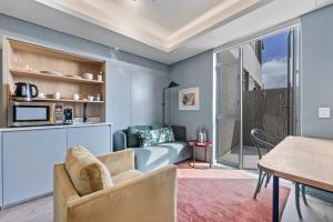 a living room with a couch and a table at Quarters 405 in Cape Town