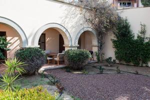 a courtyard with a table and chairs in a building at Adjacent to Aphrodite Premium Apartments I in Kouklia