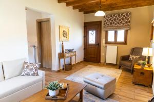 a living room with a couch and a table at Alexi's House in Kalavrita