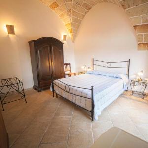 a bedroom with a large bed in a room at Masseria Fracchicchi in Galatina