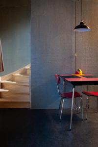 a dining room with a red table and chairs at Studio Kittel Guest Room with Private Bathroom in Bruges +22 photos