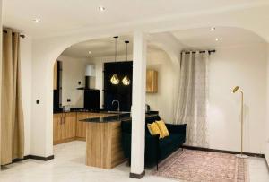 a living room with a couch and a kitchen at Oceana Residence 2 in Mont Choisy