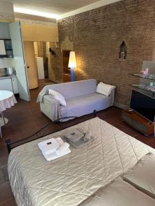a living room with a bed and a couch at La Suite del Doge - Parking in Treviso