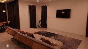 a living room with a couch and a flat screen tv at Sastred villa Mus'lim Only in Sungai Petani +10 photos