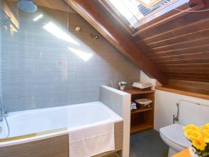 a bathroom with a bath tub and a toilet at Potxó Rural in Tirvia +18 photos