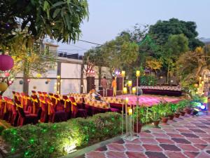 a set up for an event with chairs and lights at Harsh Villa in Prayagraj +20 photos